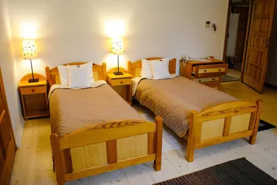 a hotel room with two beds and two lamps at Hotel Krak in Myślenice