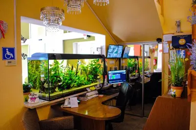 an office with a large fish tank on a desk at Hotel Krak in Myślenice