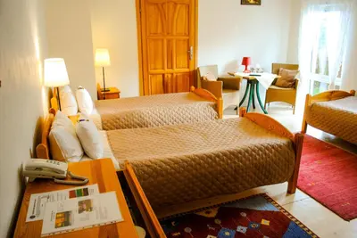 a hotel room with two beds and a living room at Hotel Krak in Myślenice