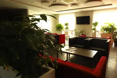 a waiting room with couches and a table and plants at Radocza Park Active & Spa in Radocza
