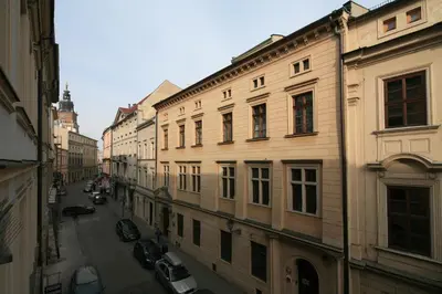 an alley with buildings and cars on a street at BRACKA 15 - Main Square Apartments by MINT APARTMENT in Kraków