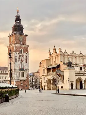 a building with a clock tower in a courtyard at BRACKA 15 - Main Square Apartments by MINT APARTMENT in Kraków