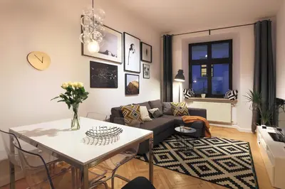 a living room with a couch and a table at BRACKA 15 - Main Square Apartments by MINT APARTMENT in Kraków