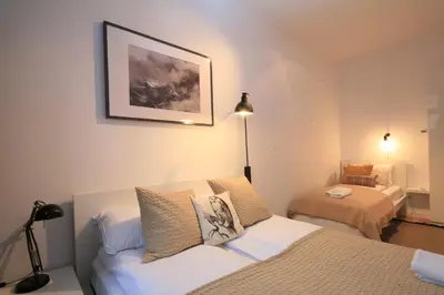 a small bedroom with a bed and a lamp at BRACKA 15 - Main Square Apartments by MINT APARTMENT in Kraków