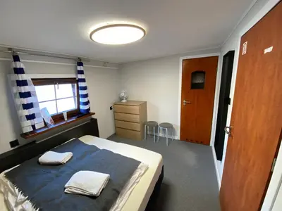 a bedroom with a bed with two towels on it at The Boat - Hostel&Chill in Kraków