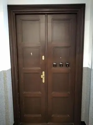 a pair of wooden doors in a building at Apartments on Miodowa in Kraków