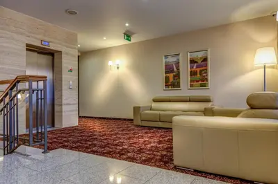 a lobby with couches and a staircase in a building at Hotel-Restauracja Platan in Chrzanów