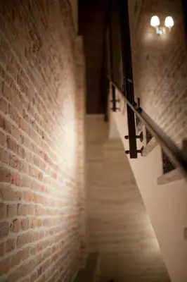 a brick hallway with a brick wall and a staircase at Hotel-Restauracja Platan in Chrzanów