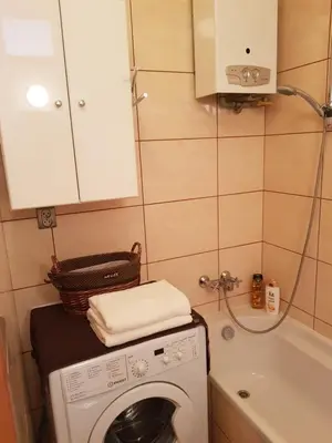 a small bathroom with a washing machine and a tub at Apartament Aga2 in Oświęcim