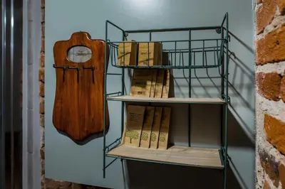 a group of books on a shelf next to a wall at Apartamenty Bluma in Kraków