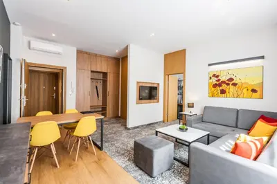 a living room with a couch and a table at K4 APARTHOTEL KRAKÓW in Kraków