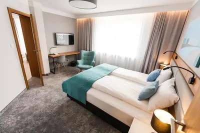 a hotel room with a bed and a desk at K4 APARTHOTEL KRAKÓW in Kraków
