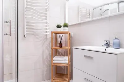 a bathroom with a sink and a shower at Househost Apartment - Kupa 2 in Kraków