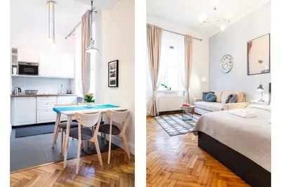 a bedroom and a living room with a bed and a table at Househost Apartment - Kupa 2 in Kraków