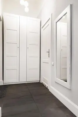 a hallway with white doors and a mirror at Househost Apartment - Kupa 2 in Kraków
