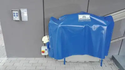 a blue plastic seat in a public restroom at Romantic Sky Apartment- 15th floor in Kraków