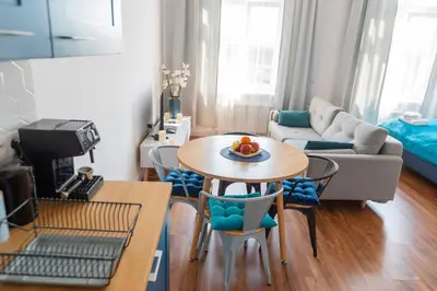 a living room with a table and chairs and a couch at Way2Stay Old Town in Kraków