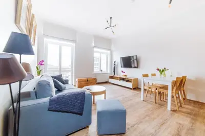 a living room with a blue couch and a table at Way2Stay Old Town in Kraków