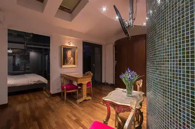 a living room with a table and a bedroom at Main Square Studio with TERRACE & Air condition in Kraków