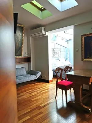 a living room with a table and chairs and a bed at Main Square Studio with TERRACE & Air condition in Kraków