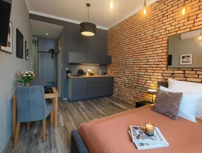 a bathroom with a white toilet and a sink at Kings City - Sławkowska Apartments in Kraków
