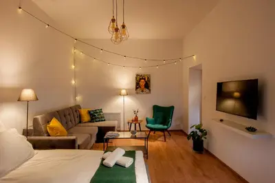 a room with a bed and a couch and a tv at Agnieszki 1 Apartment in Kraków
