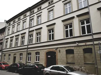 a large building with cars parked in front of it at Agnieszki 1 Apartment in Kraków