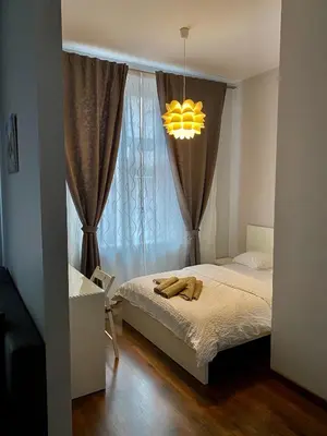 a bedroom with a bed and a chandelier at Ametyst Apartments in Kraków