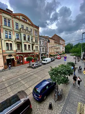 a city street with cars parked on the street at Ametyst Apartments in Kraków