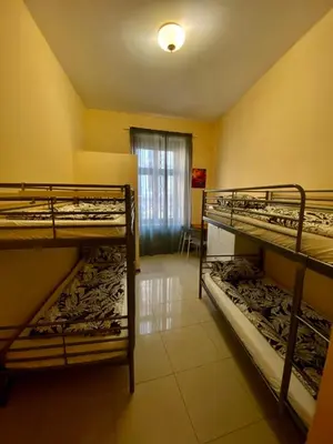 a room with three bunk beds in it at Ametyst Apartments in Kraków
