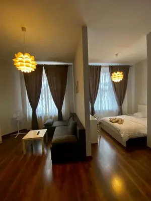 a living room with a bed and a couch at Ametyst Apartments in Kraków