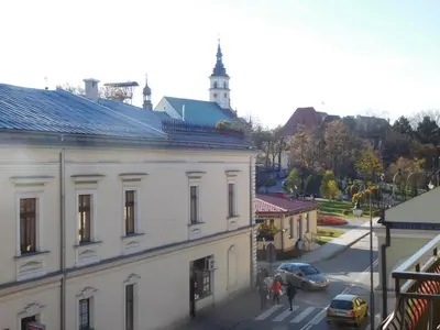 a view of a street with a white building at Apartament DERUBEIS in Wieliczka