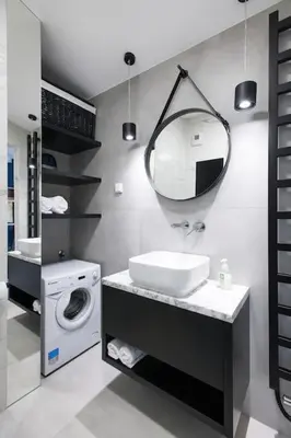 a bathroom with a sink and a washing machine at Apartament Polka Dots in Kraków