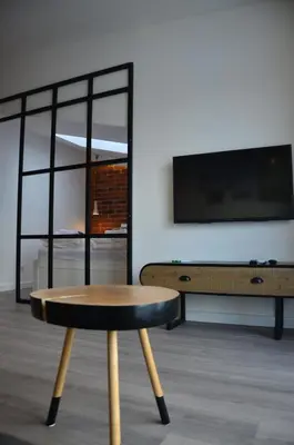 a coffee table and a tv in a living room at Apartament Polka Dots in Kraków