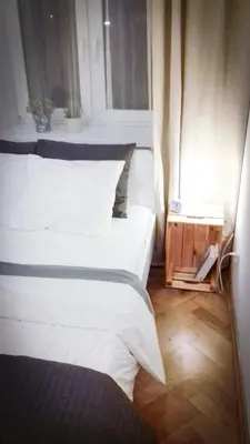 a bedroom with a white bed and a window at SL apartments in Kraków