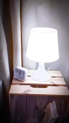 a table with a lamp and a clock on it at SL apartments in Kraków
