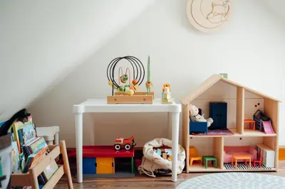 a childs play room with a white table and toys at Ostoja in Rzyki