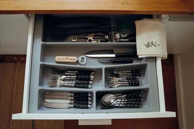 a drawer full of kitchen utensils in a cabinet at Ostoja in Rzyki