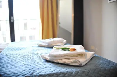 two towels sitting on top of a bed at 3D Szlak 77 Apartament in Kraków