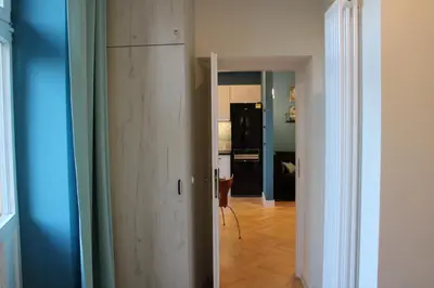 a room with a wooden cabinet and a hallway at Dominican Square by Hashtag Apartments in Kraków