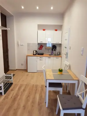 a kitchen and dining room with a table and chairs at Apartamenty Marco 3 przy Dworcu-Stare Miasto-Super Wi Fi in Kraków