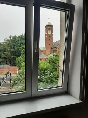 a window with a view of a clock tower at Apartamenty Marco 3 przy Dworcu-Stare Miasto-Super Wi Fi in Kraków