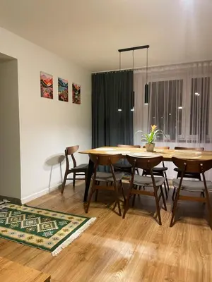 a dining room with a table and chairs at Dom pod orzechem in Spytkowice