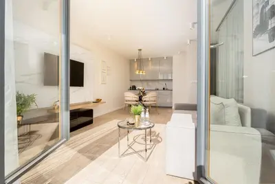 a living room with a large flat screen tv at Glossy Apart M45 in Kraków