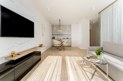 a bedroom with a large bed and a large mirror at Glossy Apart M45 in Kraków