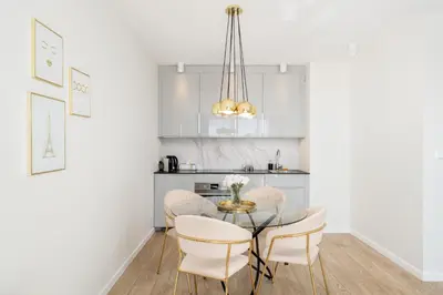 a living room with a couch and a glass table at Glossy Apart M45 in Kraków