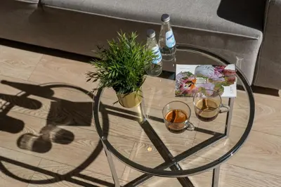 a living room with a couch and a table at Glossy Apart M45 in Kraków