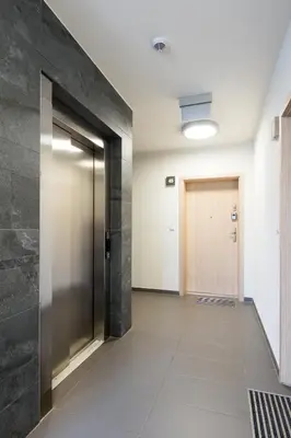 a hallway of an office building with a door at Glossy Apart M45 in Kraków