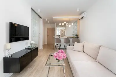 a living room with a white couch and a table at Glossy Apart M54 in Kraków