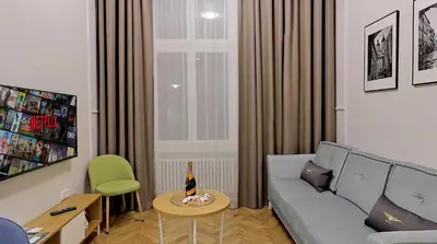 a living room with a couch and a table at Bentis Luxury Apartments in Kraków
